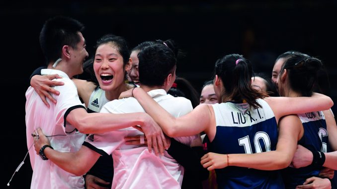 China's players celebrate after winning the women's quarter-final volleyball match between Brazil and China at the Maracanazinho stadium in Rio de Janeiro on August 16, 2016. / AFP PHOTO / Kirill KUDRYAVTSEV